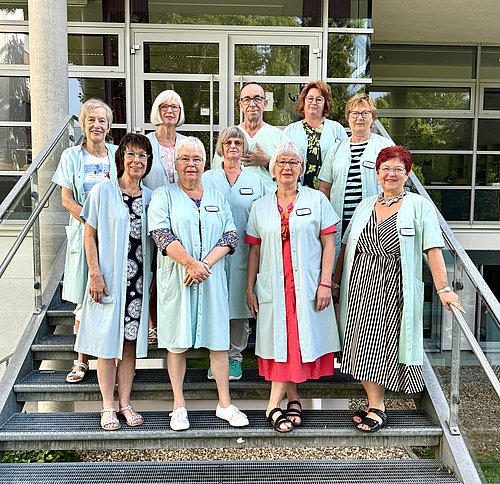 Eine Gruppe von Menschen in grünen Kitteln